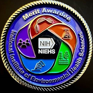 The new merit award medallions feature the NIEHS logo on the front with the specific award citation engraved on the back.