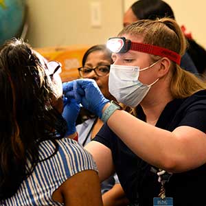 Woman performs health screening at annual WHA Conference