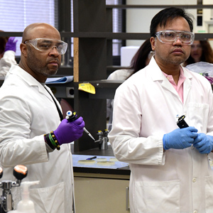 People in lab being taught proper pipetting
